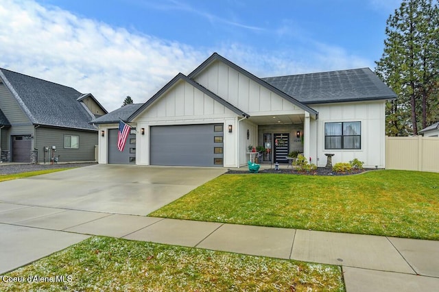 view of front of home featuring a front yard and a garage