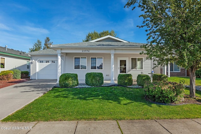 view of front of property featuring a garage and a front yard