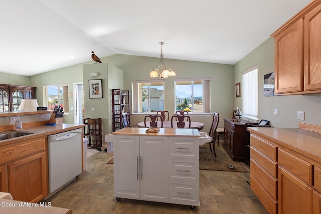 kitchen featuring white dishwasher, an inviting chandelier, a center island, hanging light fixtures, and lofted ceiling