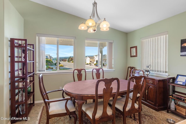 dining area with a chandelier and lofted ceiling