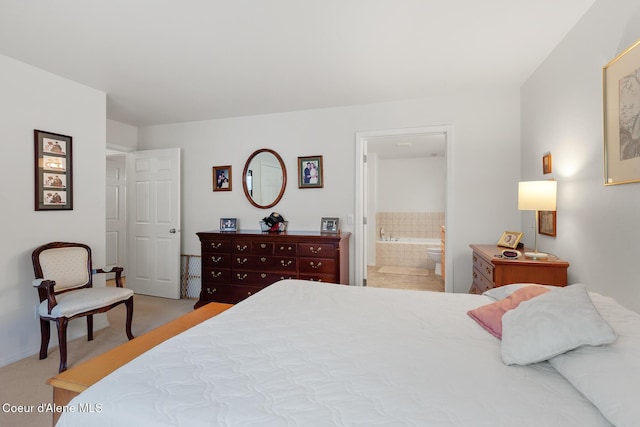 bedroom featuring carpet flooring and ensuite bath