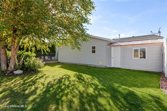 rear view of house featuring a lawn