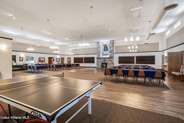 playroom featuring hardwood / wood-style floors and a fireplace