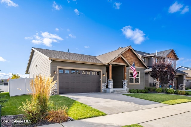 craftsman inspired home with a front yard and a garage