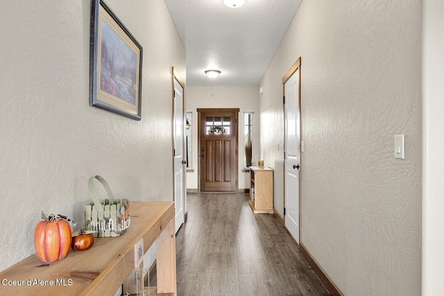 interior space featuring a textured ceiling and dark hardwood / wood-style flooring