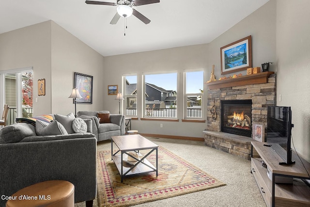 carpeted living room with a fireplace, lofted ceiling, ceiling fan, and a healthy amount of sunlight