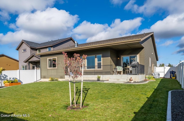 rear view of property featuring a yard