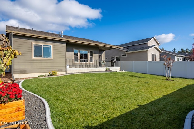 rear view of property with a lawn