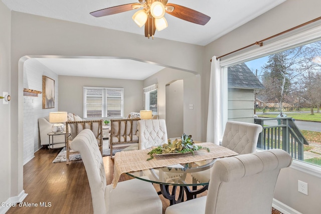 dining space with ceiling fan and dark hardwood / wood-style flooring