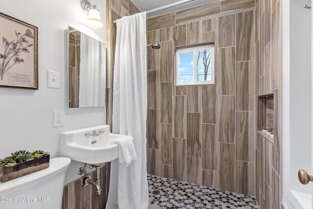 bathroom featuring walk in shower and toilet