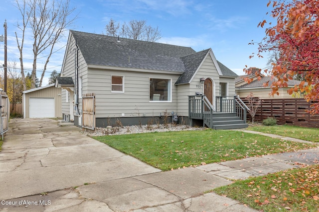 bungalow-style home with an outbuilding, a front lawn, and a garage