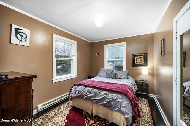 bedroom with crown molding and a baseboard radiator