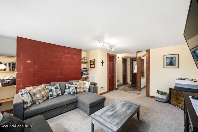 living room with light colored carpet and track lighting