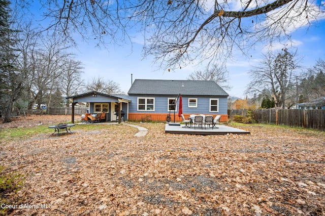 rear view of house featuring a wooden deck