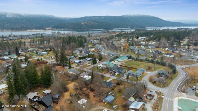 drone / aerial view with a water and mountain view