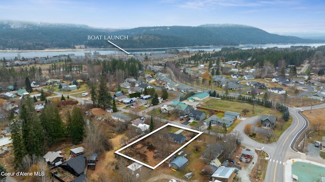 drone / aerial view featuring a water and mountain view