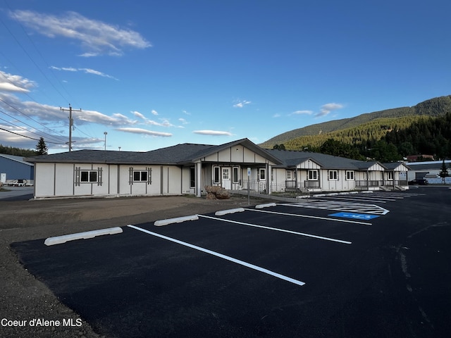 view of vehicle parking featuring a mountain view