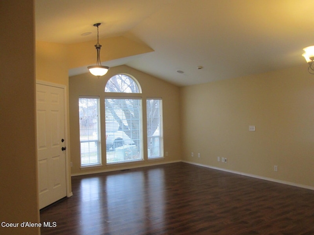 foyer entrance with dark hardwood / wood-style flooring and an inviting chandelier