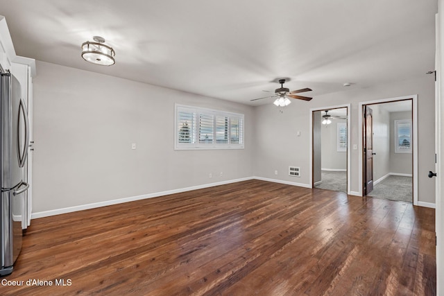 interior space with ceiling fan and dark hardwood / wood-style flooring