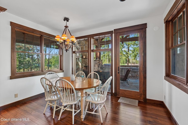 6126 S Gozzer Rd, Harrison, ID 83833 - dining space featuring dark hardwood / wood-style floors and a notable chandelier
