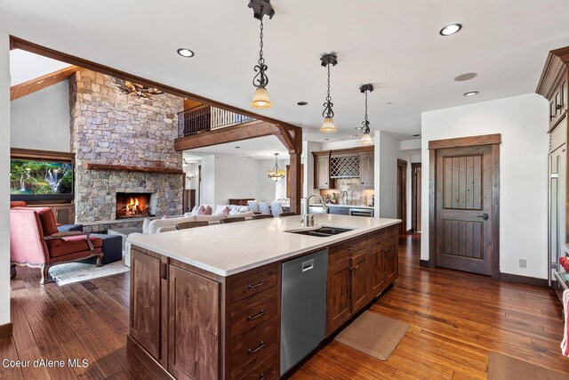 6126 S Gozzer Rd, Harrison, ID 83833 - kitchen with dishwasher, sink, dark wood-type flooring, hanging light fixtures, and an island with sink