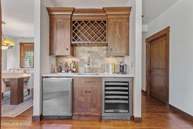6126 S Gozzer Rd, Harrison, ID 83833 - bar with wine cooler, sink, decorative light fixtures, and dark hardwood / wood-style flooring