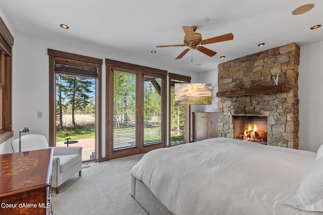 6126 S Gozzer Rd, Harrison, ID 83833 - carpeted bedroom featuring access to outside, ceiling fan, and a fireplace