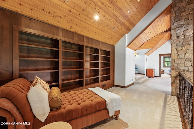 6126 S Gozzer Rd, Harrison, ID 83833 - living area with built in shelves, a stone fireplace, light colored carpet, vaulted ceiling, and wood ceiling
