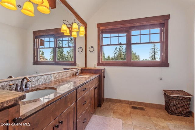 6126 S Gozzer Rd, Harrison, ID 83833 - bathroom with a wealth of natural light, vanity, a chandelier, and vaulted ceiling