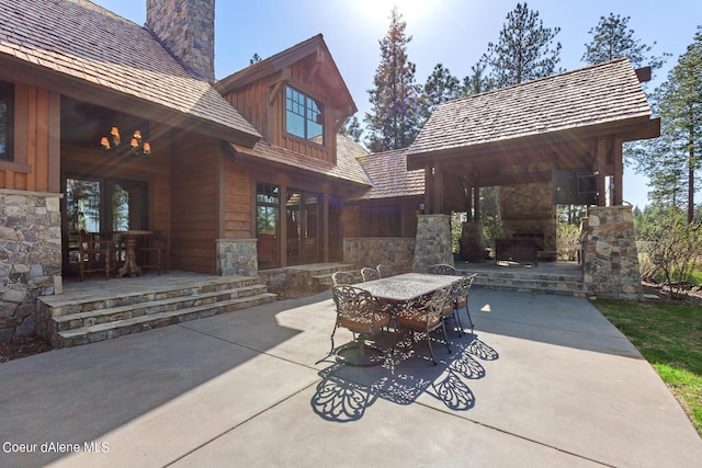 6126 S Gozzer Rd, Harrison, ID 83833 - view of patio featuring an outdoor stone fireplace