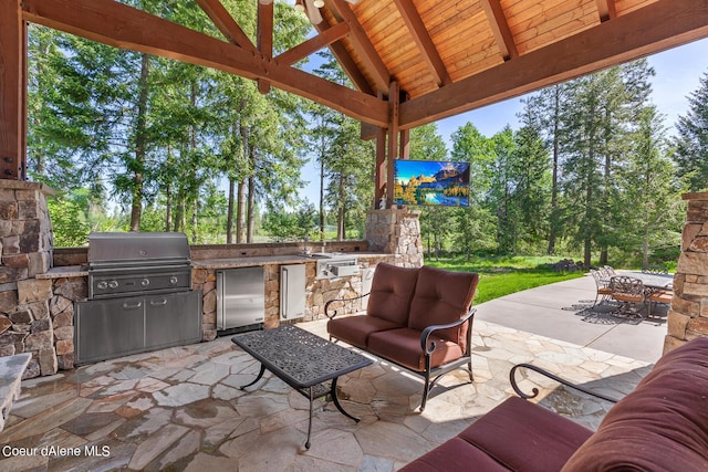 6126 S Gozzer Rd, Harrison, ID 83833 - view of patio featuring an outdoor living space, area for grilling, and exterior kitchen