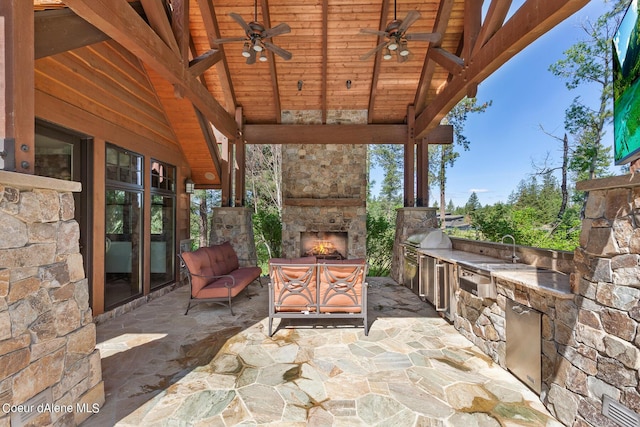 6126 S Gozzer Rd, Harrison, ID 83833 - view of patio with an outdoor stone fireplace, sink, ceiling fan, and exterior kitchen
