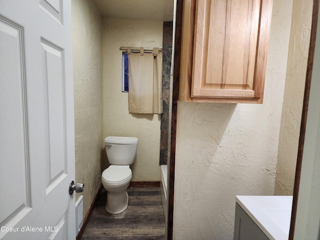 bathroom featuring vanity, toilet, and wood-type flooring