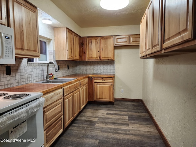 kitchen featuring decorative backsplash, a textured ceiling, white appliances, dark wood-type flooring, and sink