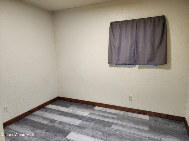 spare room with hardwood / wood-style flooring