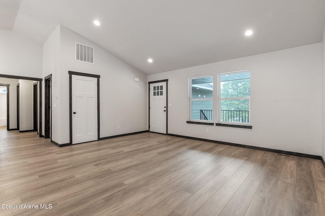 interior space with high vaulted ceiling and light hardwood / wood-style floors