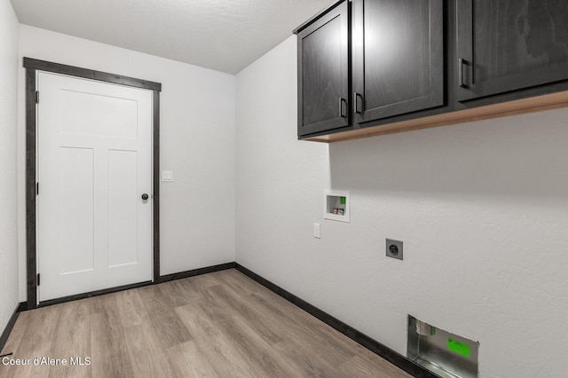 laundry room with hookup for an electric dryer, washer hookup, cabinets, and light hardwood / wood-style flooring