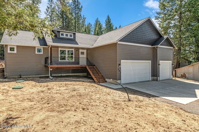 view of front of home featuring concrete driveway, stairway, and a garage