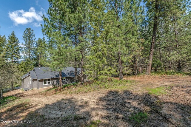 view of yard with a forest view