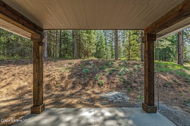 view of patio featuring a wooded view