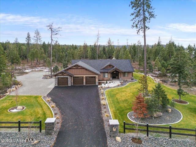 craftsman-style home featuring a garage and a front lawn