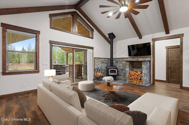 living room with beamed ceiling, dark hardwood / wood-style flooring, a wood stove, and high vaulted ceiling