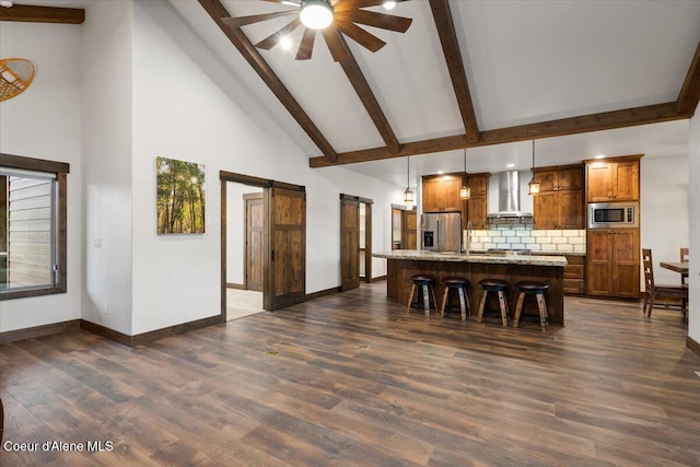 dining space with a barn door, high vaulted ceiling, ceiling fan, and dark wood-type flooring