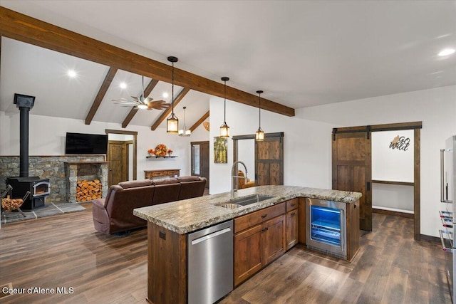 kitchen featuring ceiling fan, sink, wine cooler, stainless steel dishwasher, and decorative light fixtures