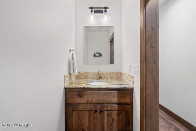 bathroom featuring vanity and wood-type flooring