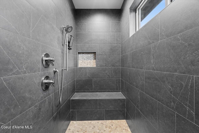 bathroom with a tile shower