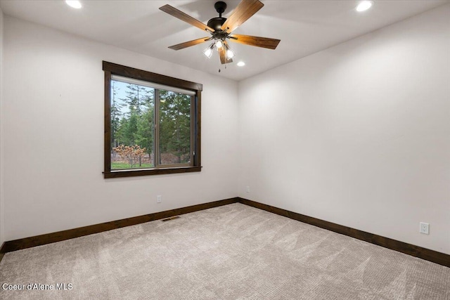 spare room featuring carpet flooring and ceiling fan