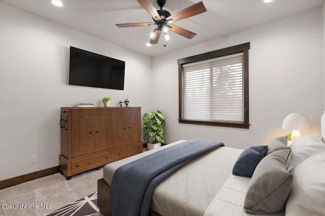 bedroom with ceiling fan and light colored carpet