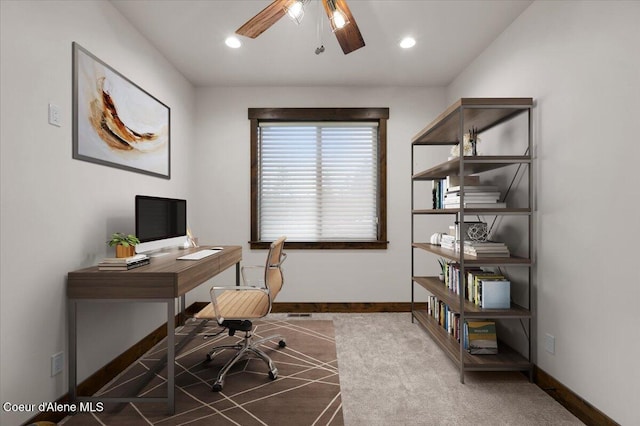 carpeted home office with ceiling fan