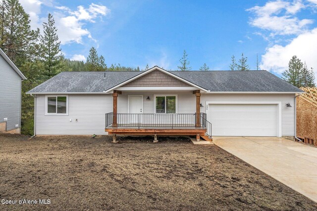 ranch-style home featuring a porch and a garage